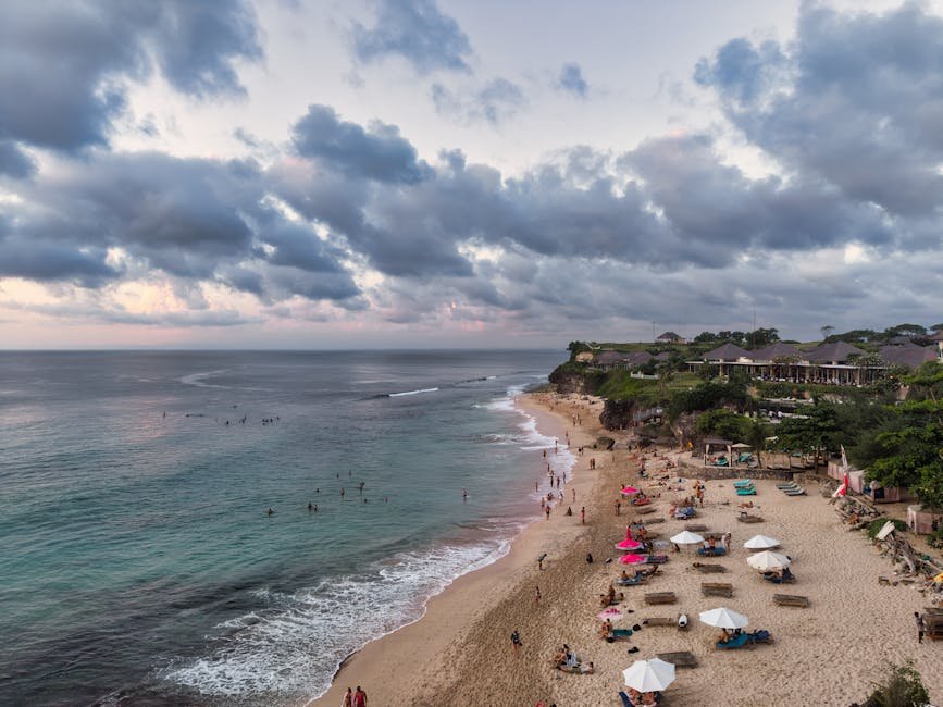 pexels-photo-36095243-36095243 Stunning aerial view of a beach in Bali, Indonesia with visitors at sunset.
