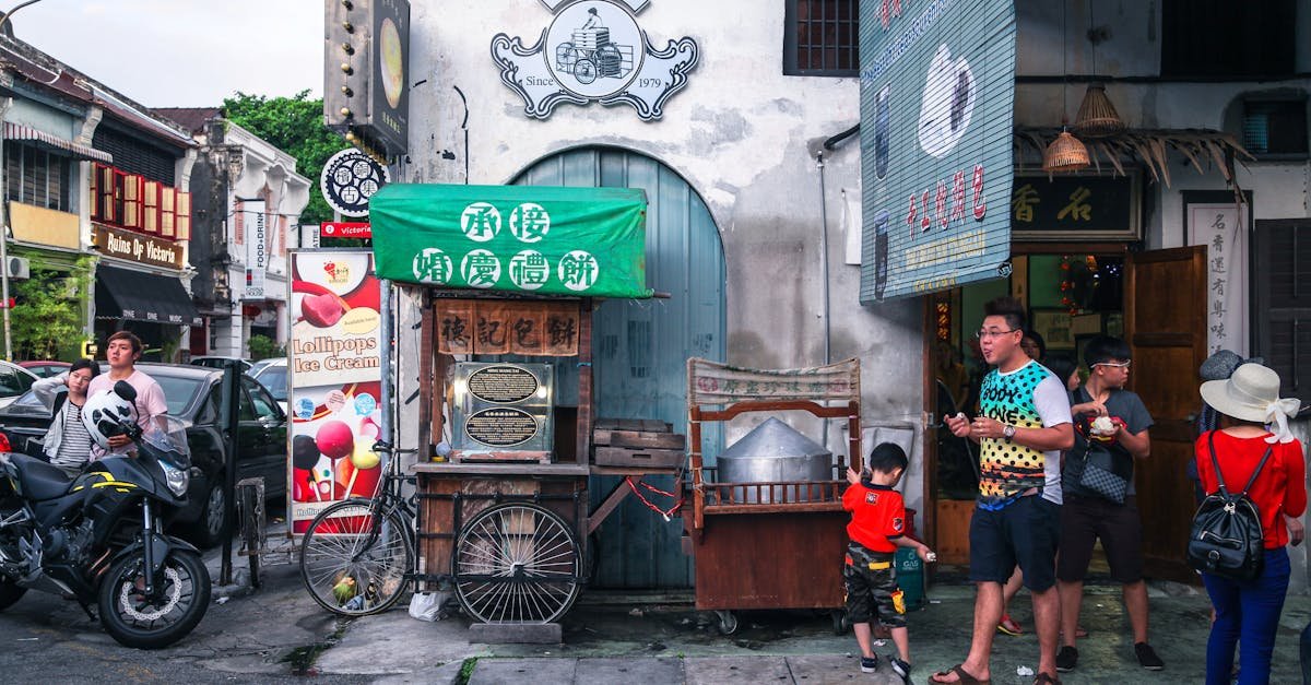 Lively street vendor scene with food stalls and people walking by, capturing vibrant urban life.