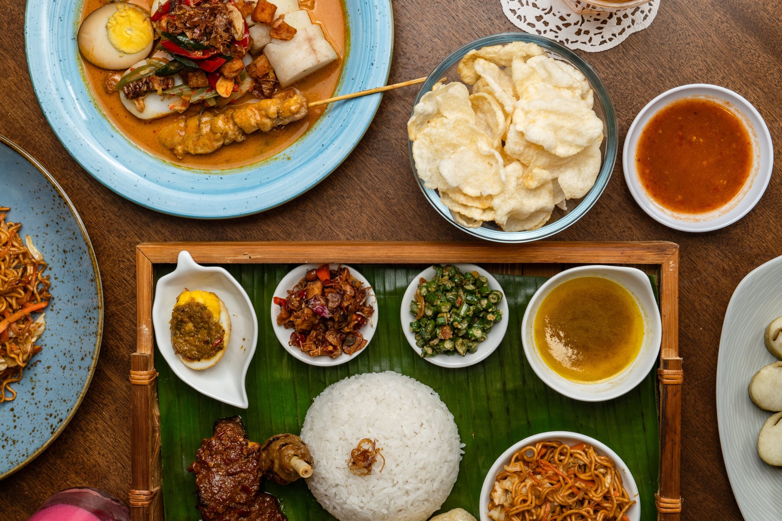 Penang Food Guide: Must try food in Penang 13 Delicious assortment of traditional Indonesian foods beautifully arranged for a feast.